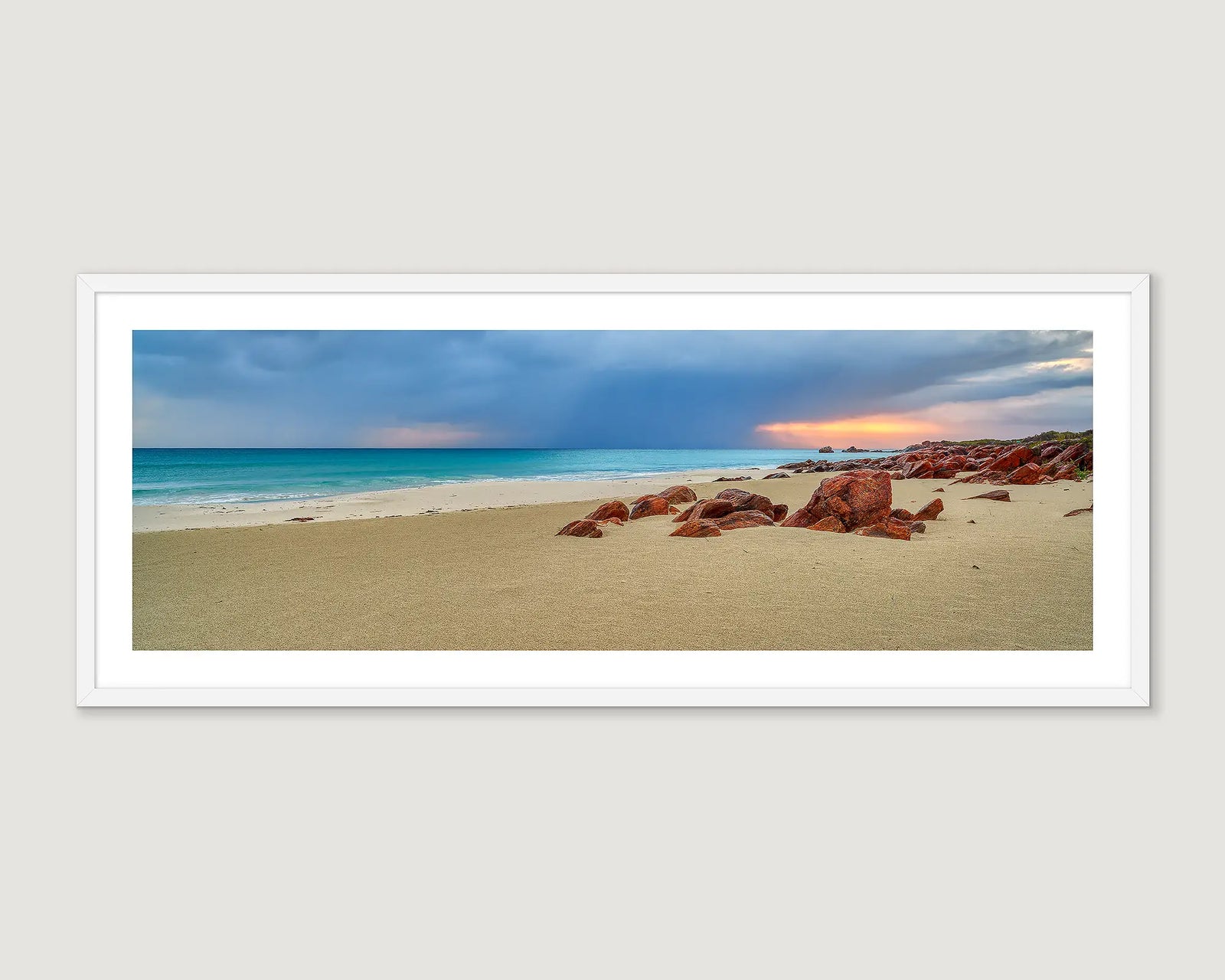 Framed coastal wall art print of red rocks and turquoise ocean at Geographe Bay. 