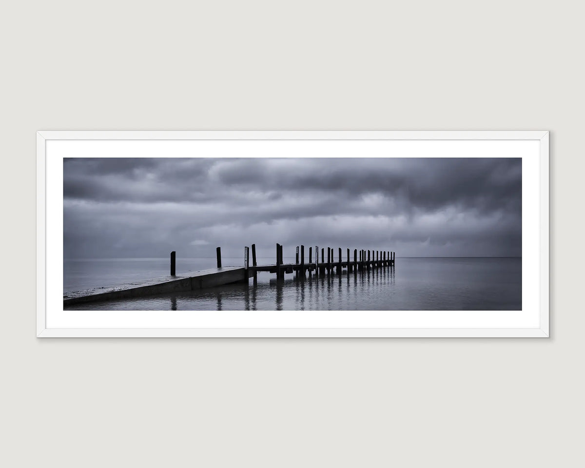 Framed wall art print of a timber jetty at Quindalup in stormy weather. 
