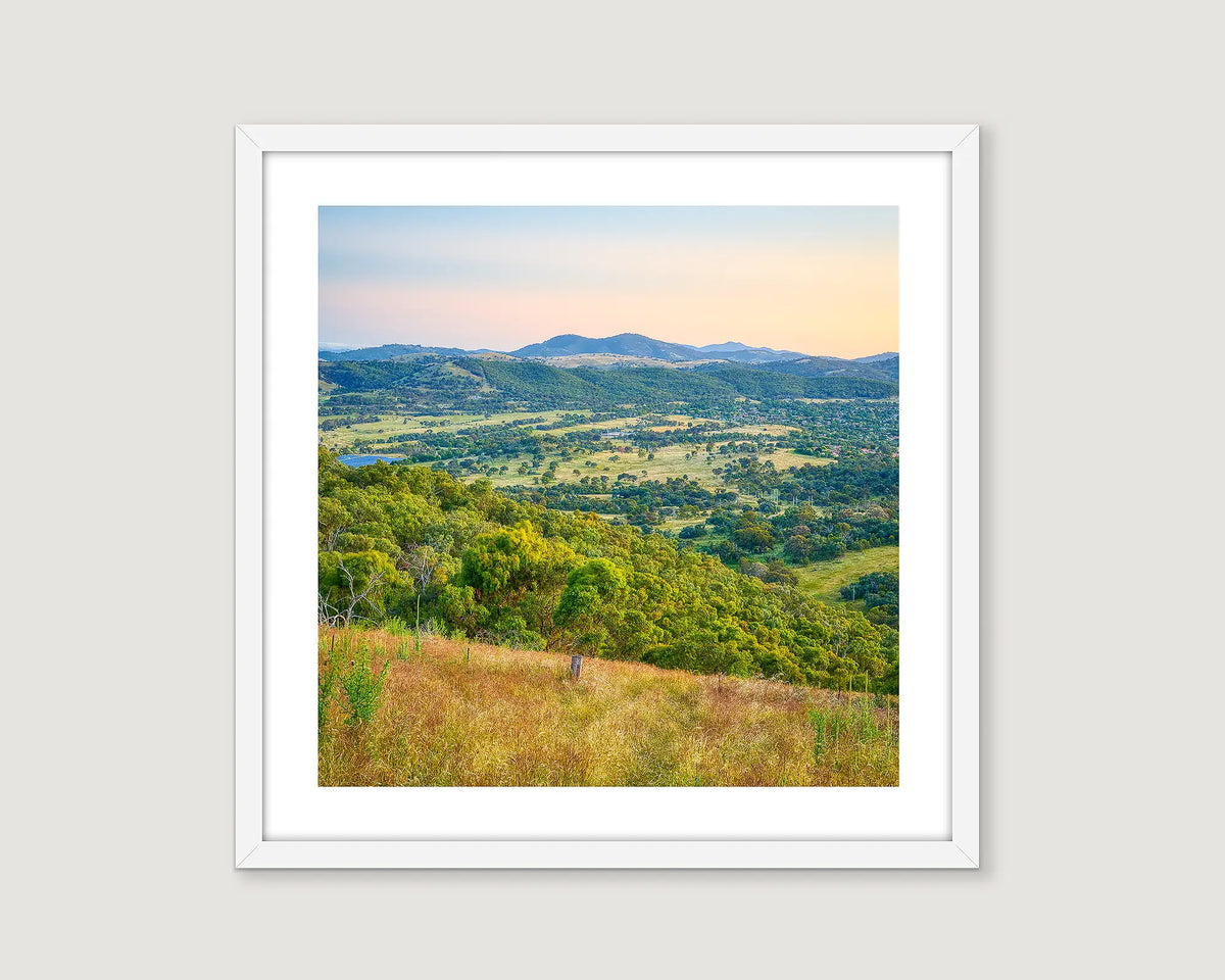 Framed print of a scenic landscape of southern Canberra with green hills and mountains.