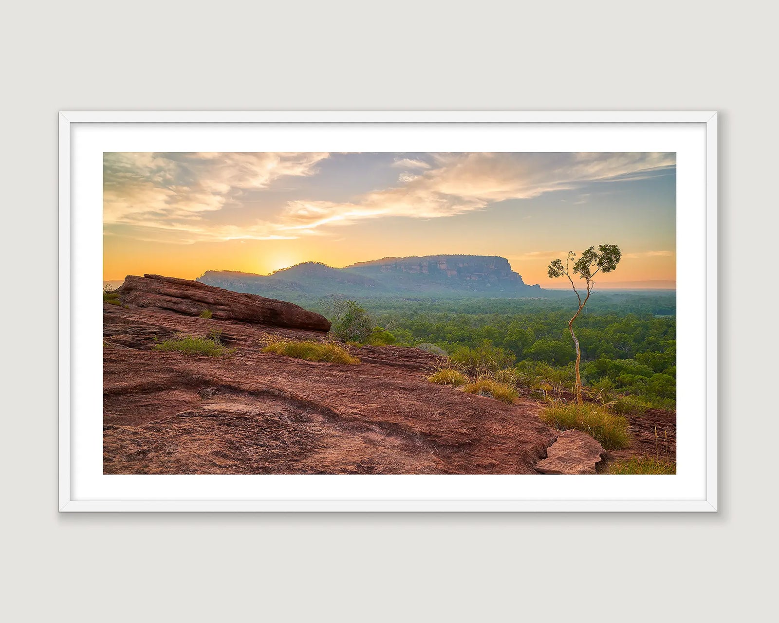 Framed photograph of rock formations and greenery at Kakadu at sunrise.