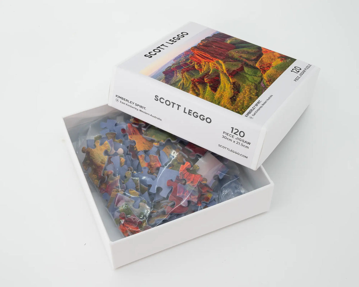 Kimberley Spirit 120 piece jigsaw puzzle box lid open with puzzle pieces inside.