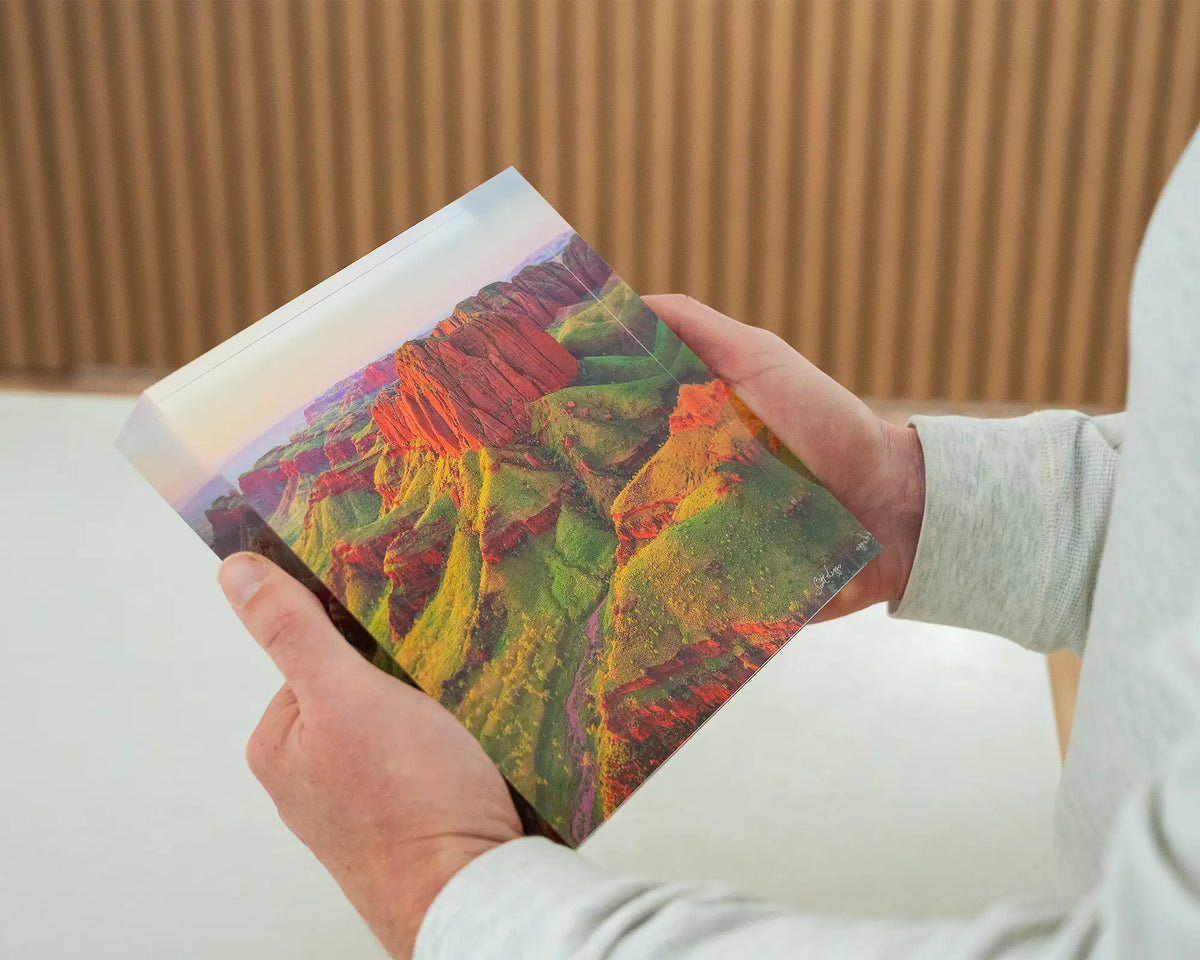 Kimberley Spirit. Acrylic block Ragged Range, The Kimberley, Western Australia, held in hands.