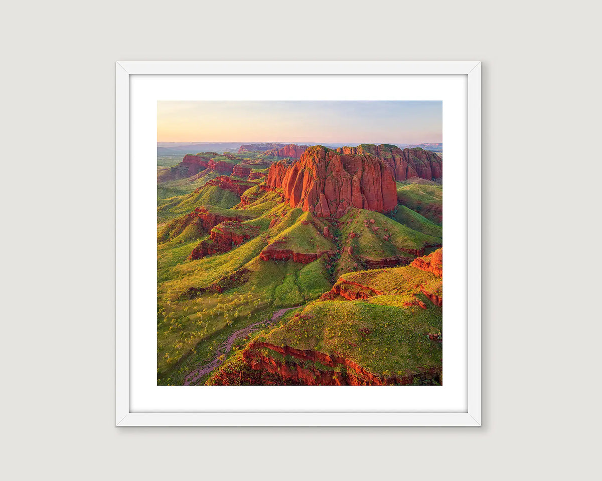 Framed photograph of rock formations and cliffs with greenery at the Kimberley.