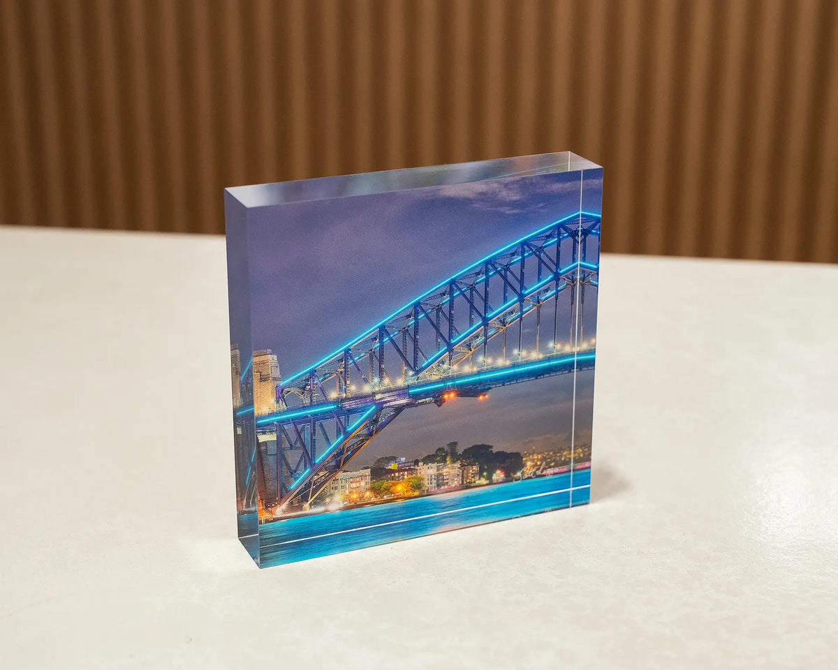 Kirribilli Colours. Acrylic block of Vivid Festival Sydney Harbour Bridge, sitting on a desk.