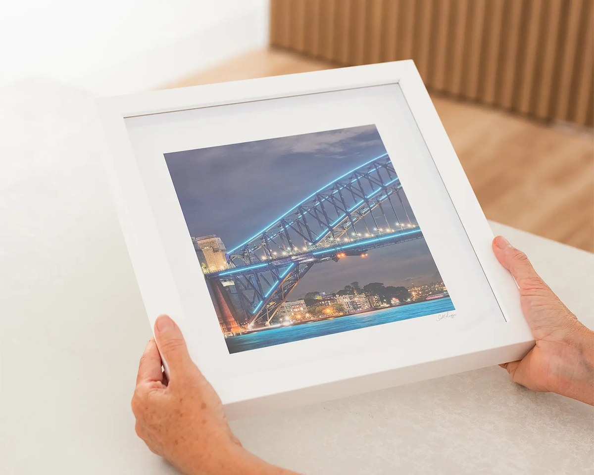 Kirribilli Colours Sydney small frame artwork with a white frame being held.