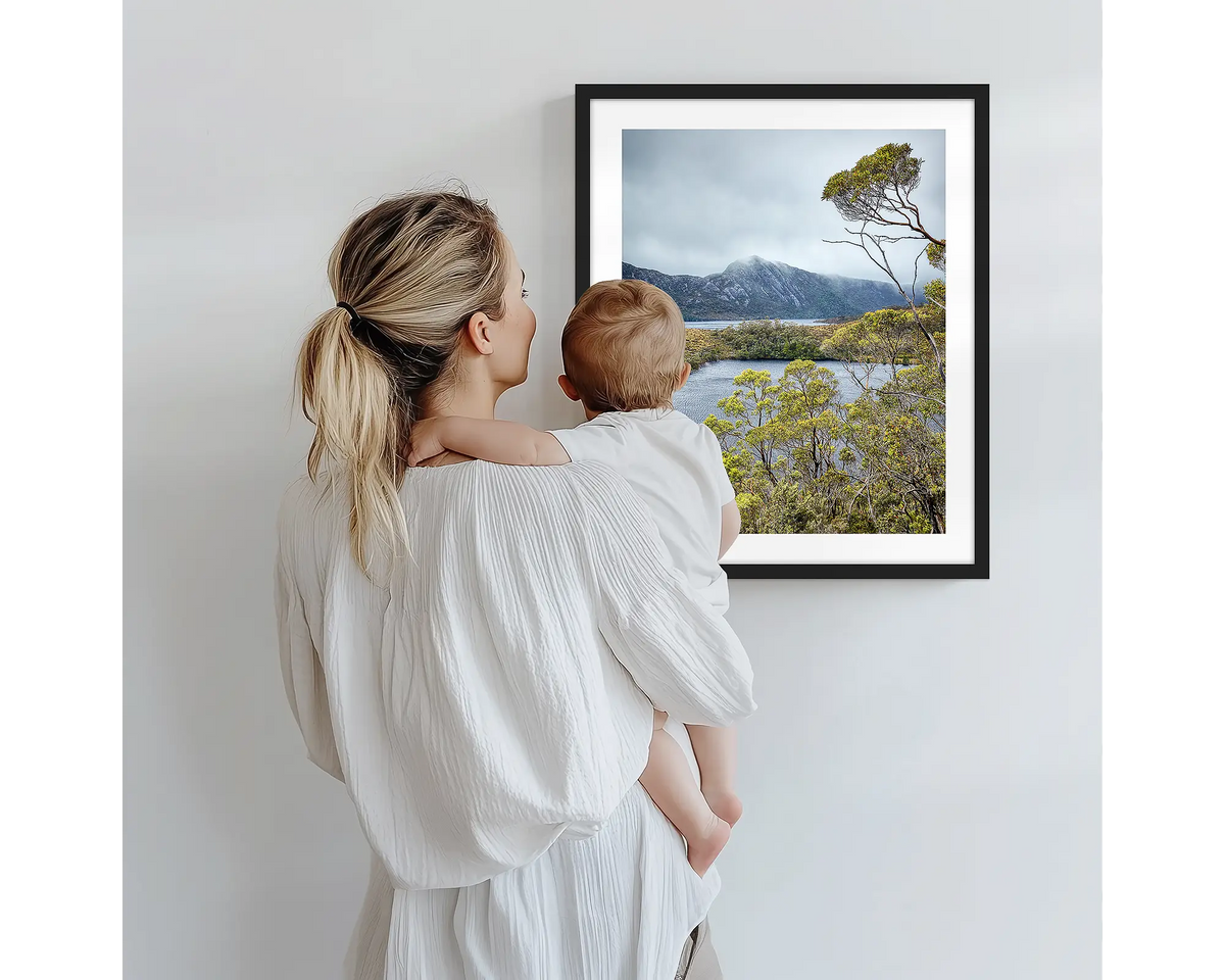 Lake View. Tasmanian photography artwork with a black frame, being admired by a mother and baby. 
