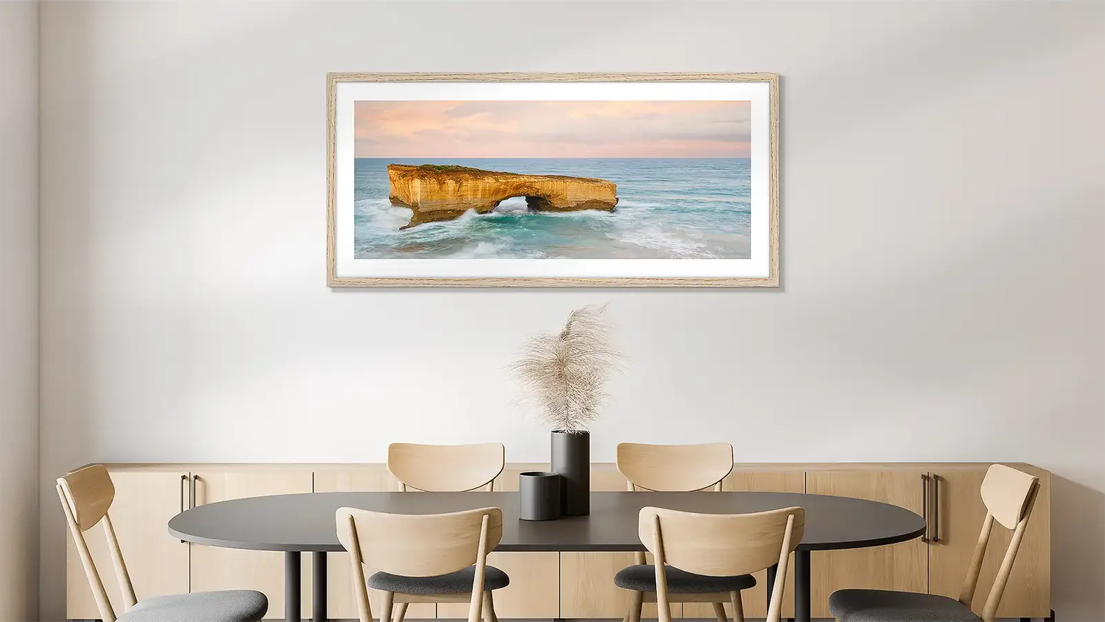 Large Great Ocean Road wall art print of London Bridge, with timber frame, hung in dining room.