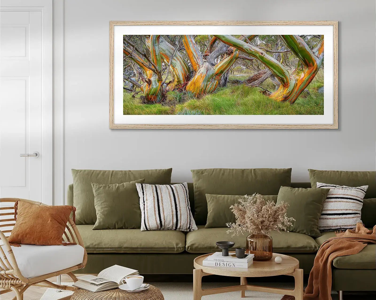 Large wall art print hung above couch in lounge room.