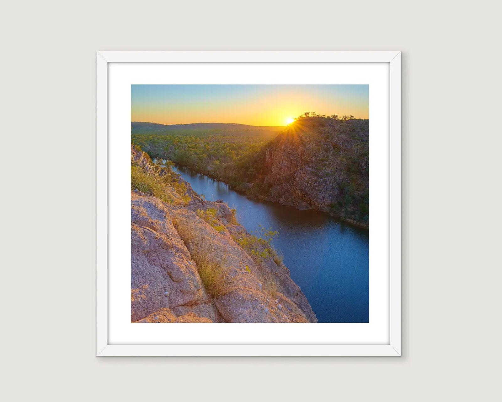 Framed photograph of a sunset over Katherine Gorge with rocky cliffs.