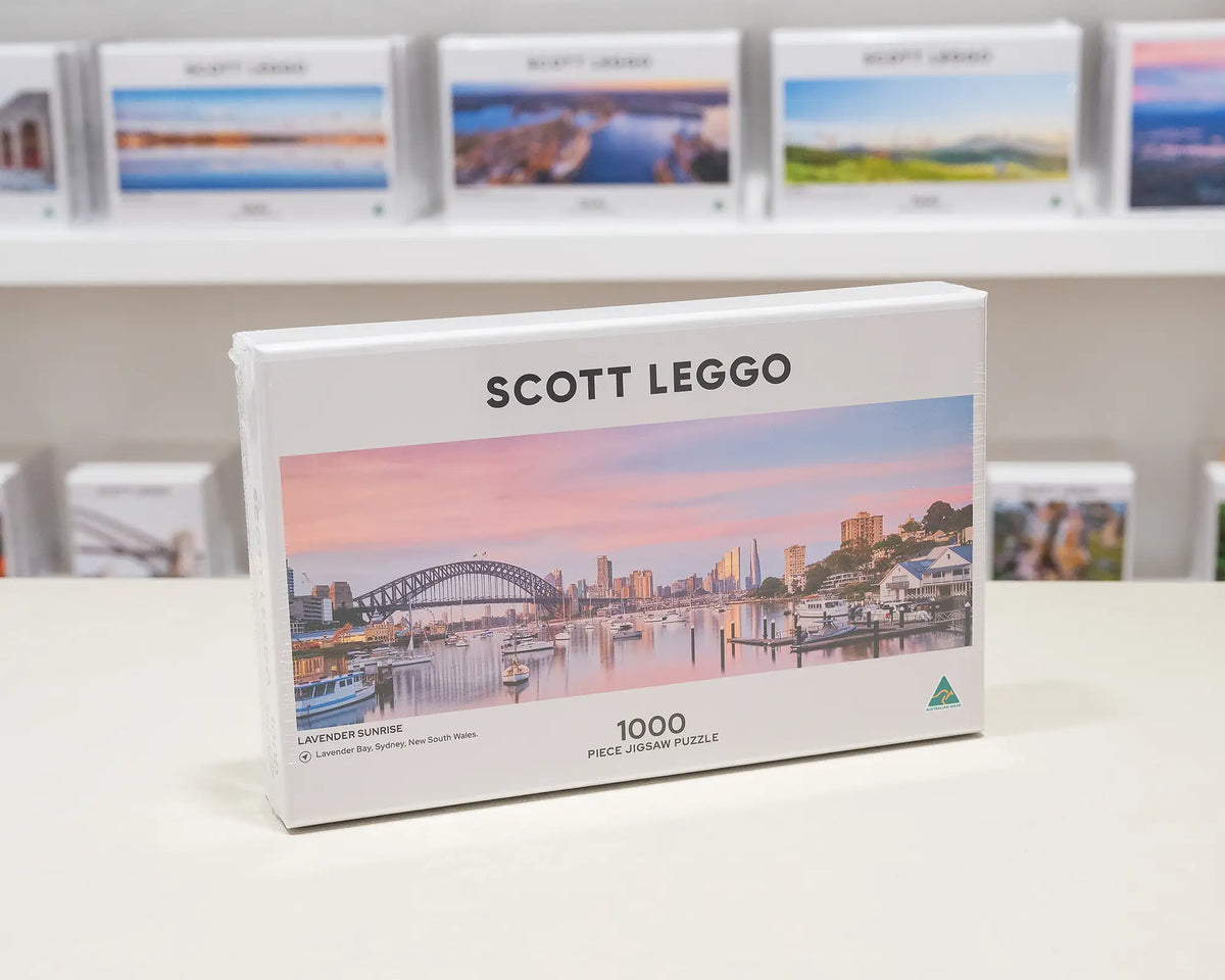 Lavender Sunrise. 1000 piece jigsaw puzzle of Lavender Bay, Sydney, on gallery desk.
