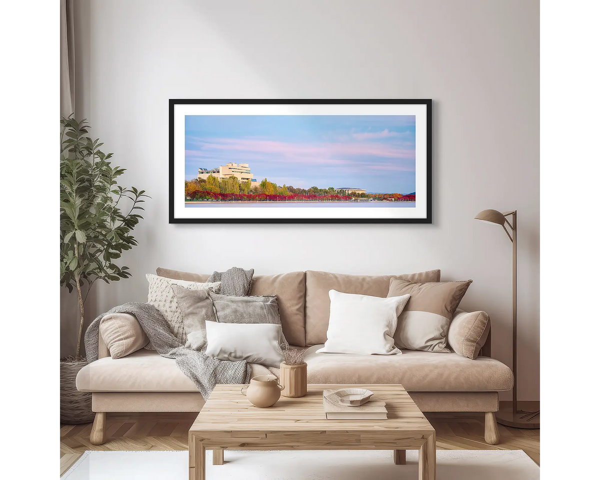 Law and Books. Framed wall art print of the High Court and National Library, with a black frame, hung above a couch.