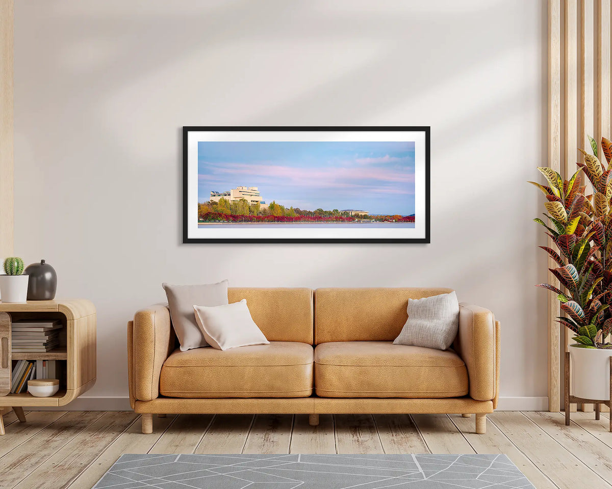 Law and Books. Framed wall art print of the High Court and National Library, with a black frame, hung above a leather couch.