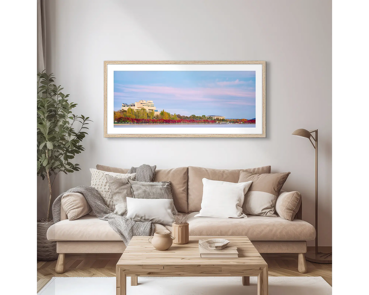 Law and Books. Framed wall art print of the High Court and National Library, with a Tasmanian Oak frame, hung above a couch.