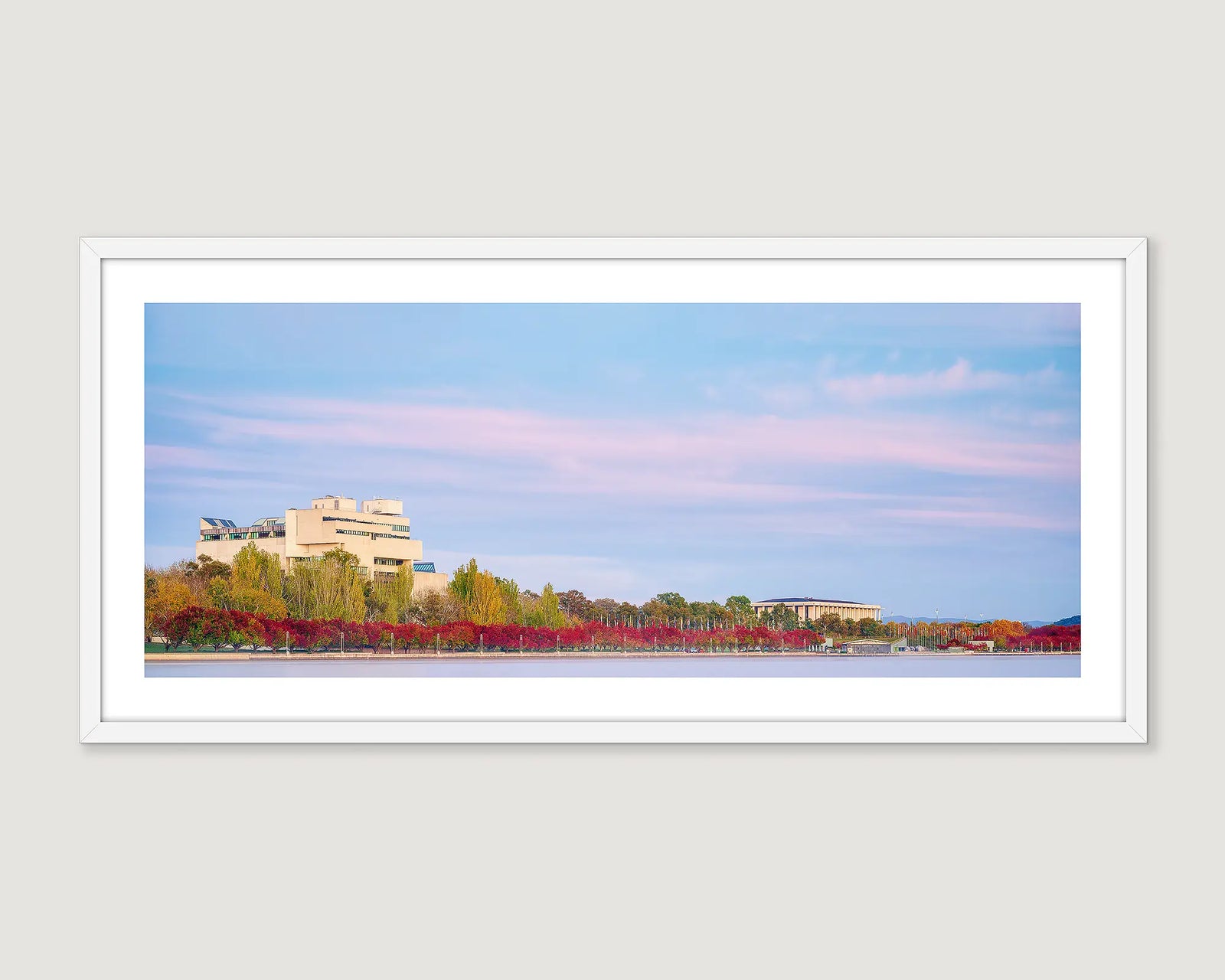 Wall art print of the Library and the Law Courts with autumn leaves turning red around Lake Burley Griffin. 