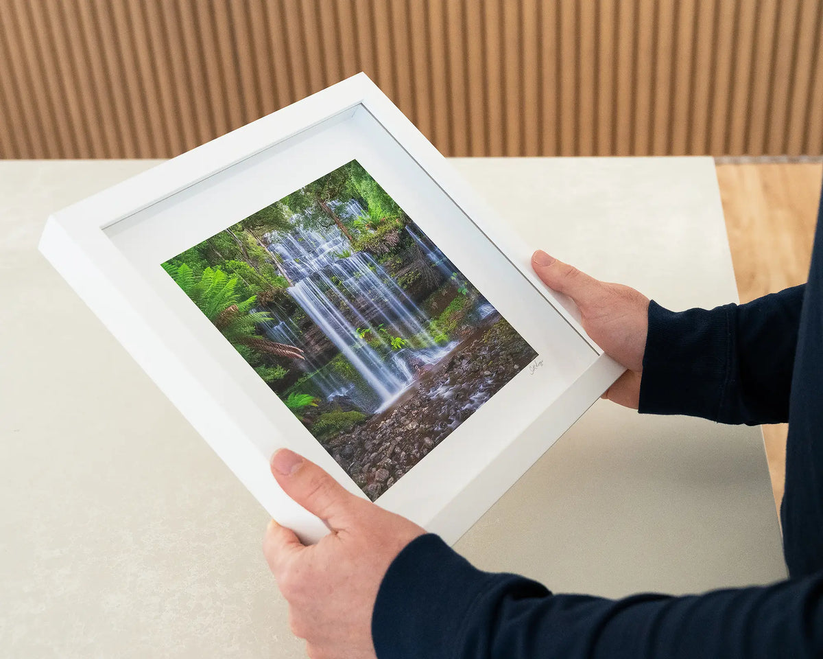 Layers. Russell Falls Mount Field National Park, Tasmania, small framed print with white frame being hand held.
