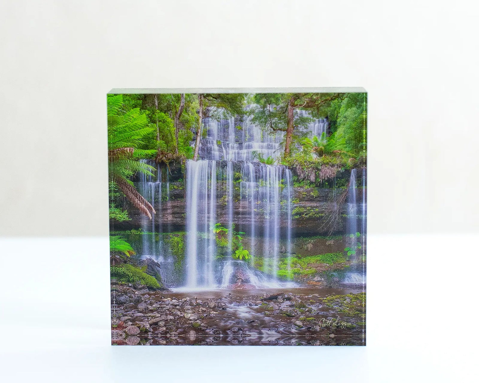 Layers Tasmanian waterfall acrylic block displayed on a desk. 
