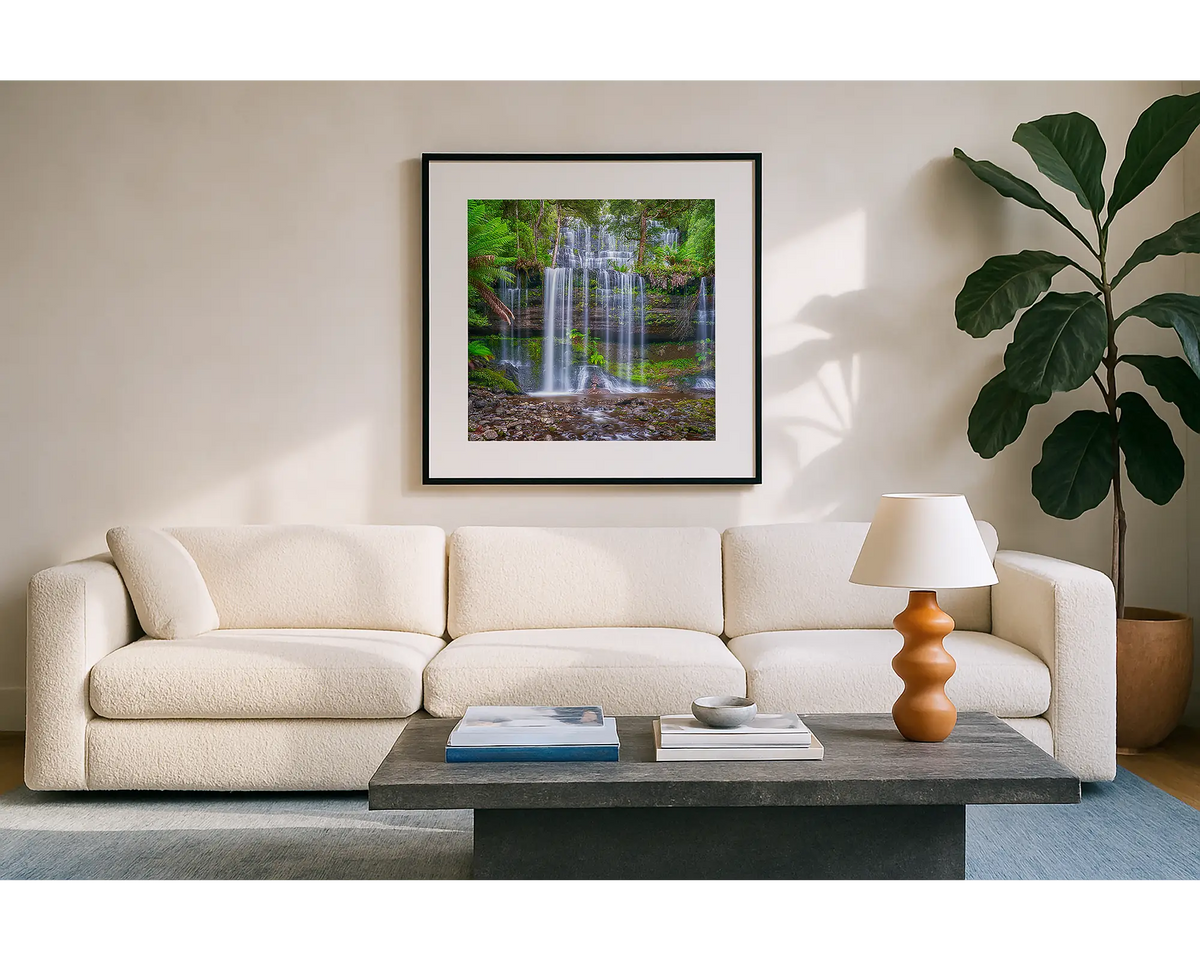 Layers. Wall art print of Russell Falls, Tasmania, with a black frame hung in a sunlit lounge room. 