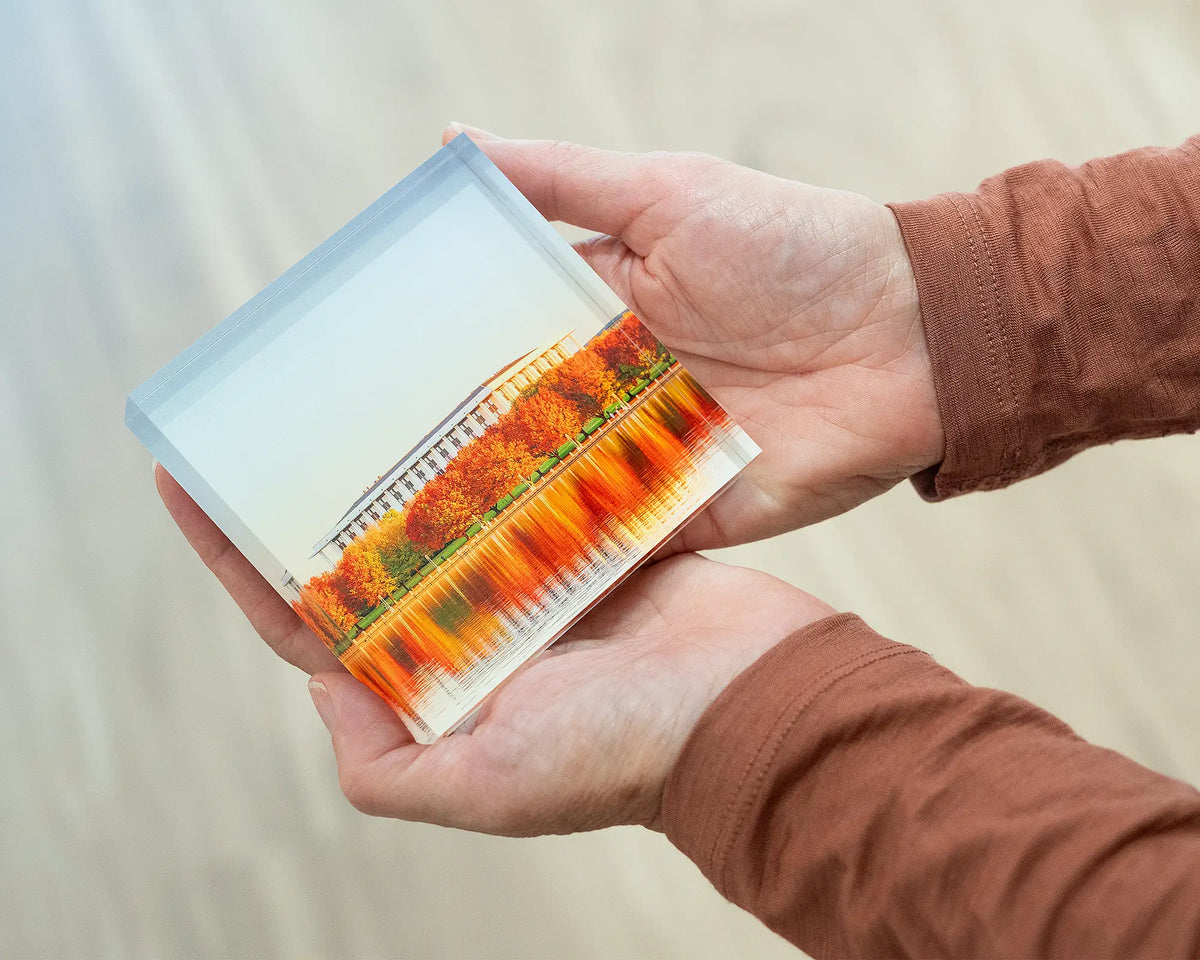 Library Reds. Acrylic block of the National Library of Australia, being held in hands.