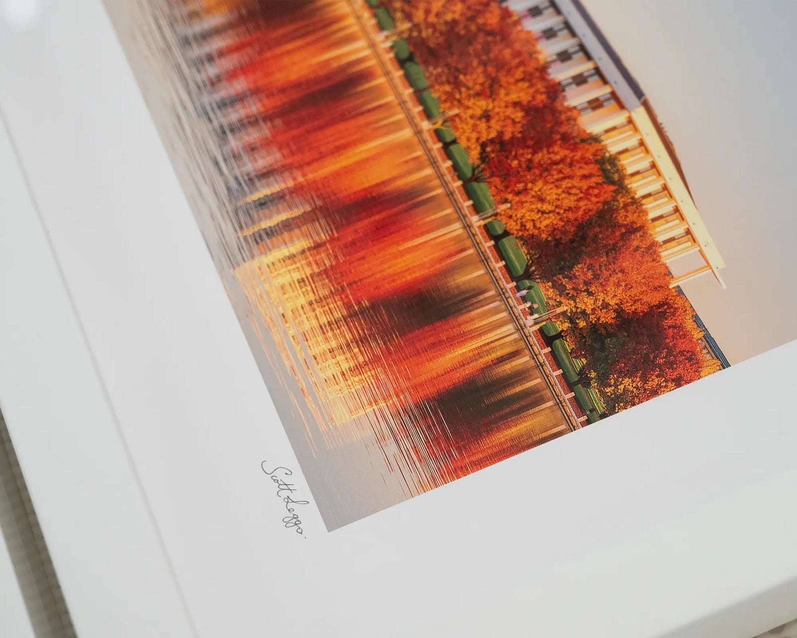 Framed wall art print of the National Library of Australia, with trees turning red in autumn, alongside Lake Burley Griffin. 