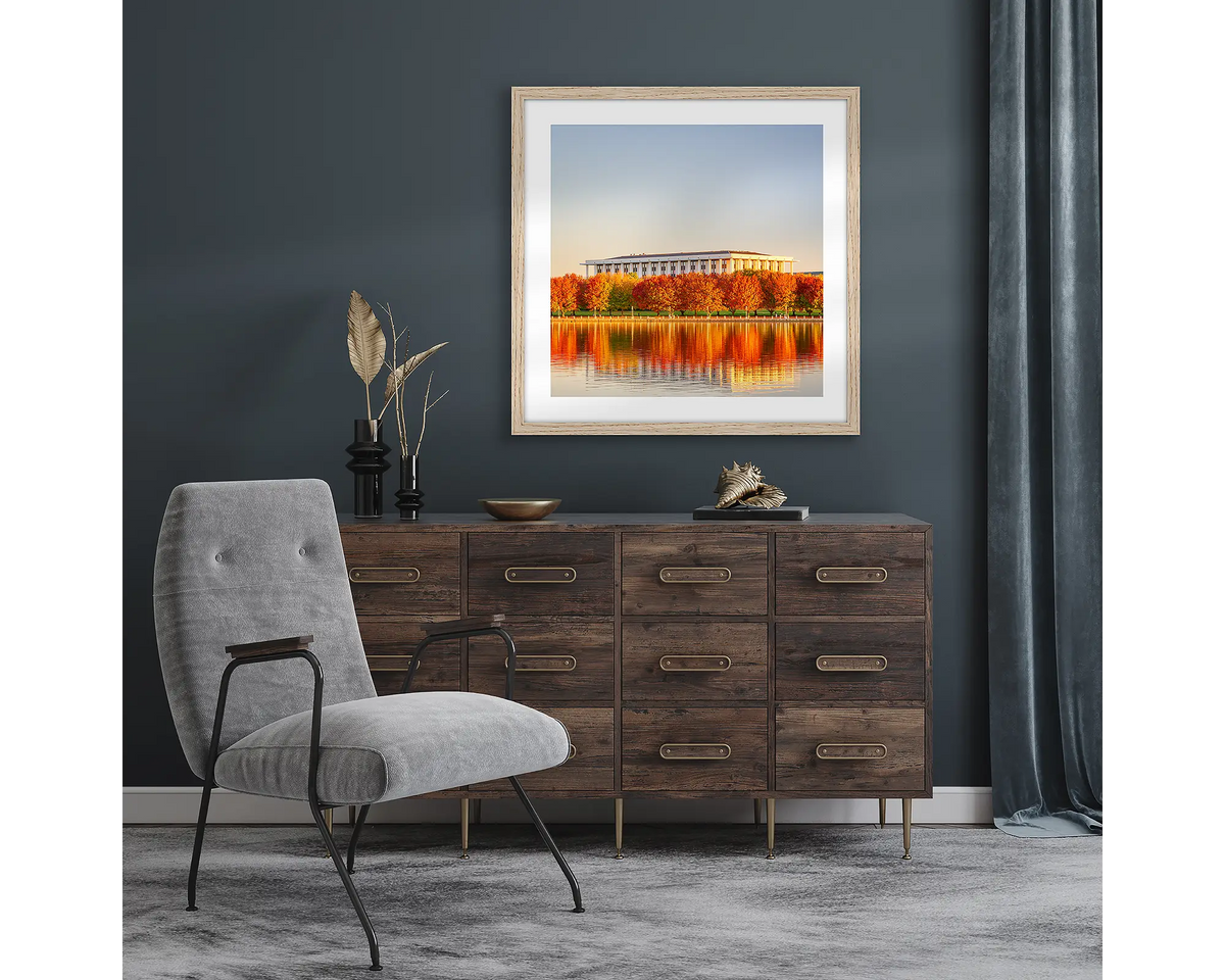 Library Reds. Wall art print with timber frame of autumn sunset over National Library of Australia, Canberra, hung in a room with dark walls.