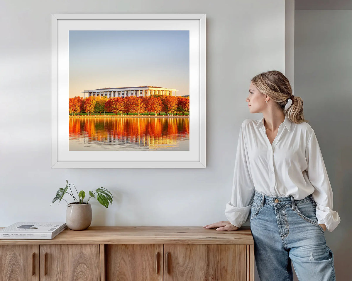Library Reds. Wall art print with white frame featuring the National Library of Australia, hung above a side table.