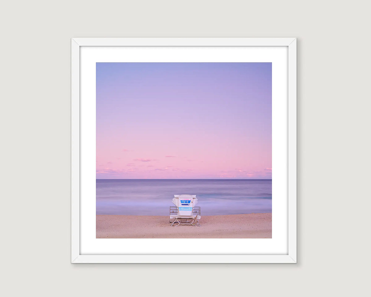 Framed photograph of a coastal sunset  and a lifeguard chair facing the beach at Bondi beach, Sydney. 
