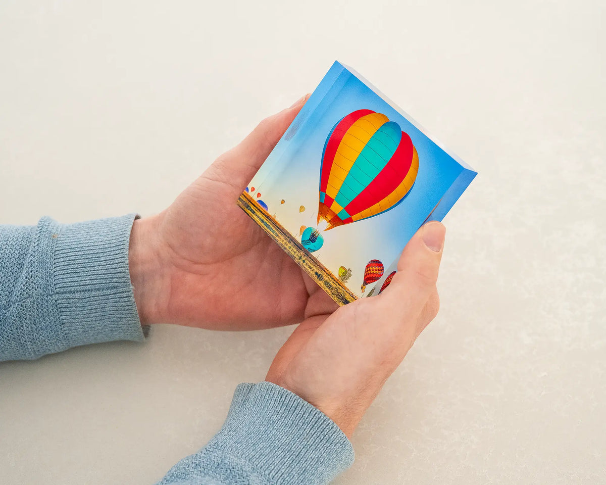 Lift. Canberra balloon spectacular acrylic block being held in hands.