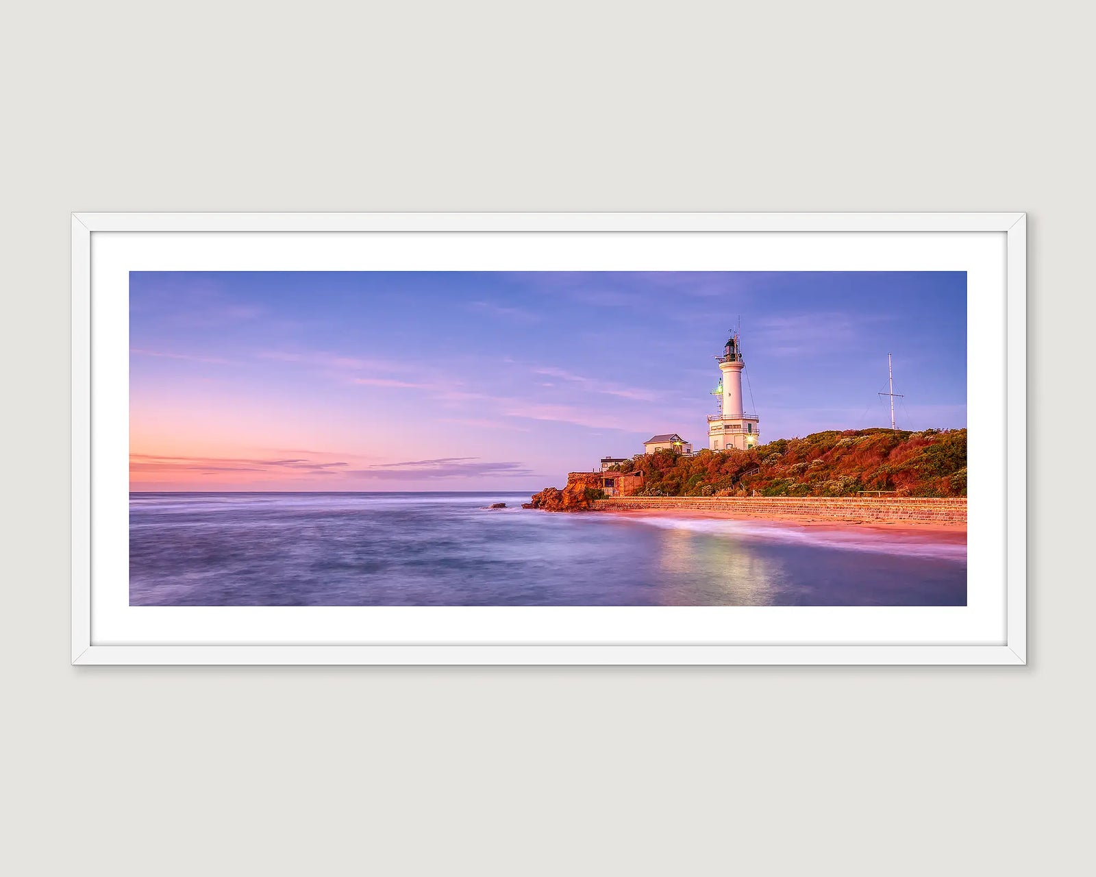 Framed wall art print of a coastal scene of Port Lonsdale lighthouse and a sunrise reflecting into Port Phillip Bay. 