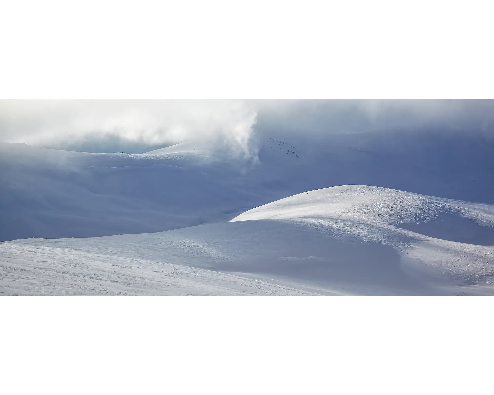 Light Show. Light filtering through clouds, over a snow covered Snowy River and main range, Kosciuszko National Park. 