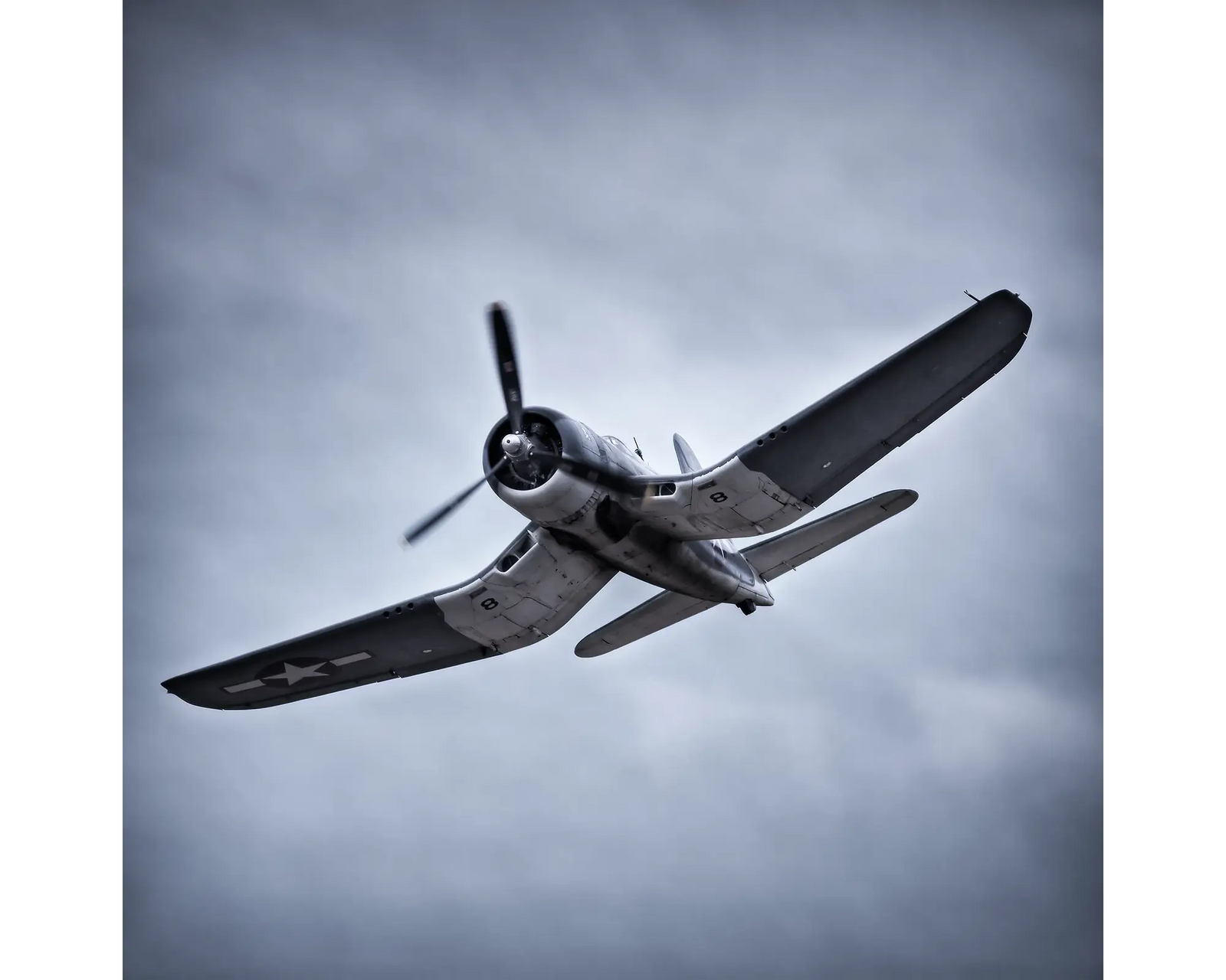 Goodyear FG-1D Corsair flying above.