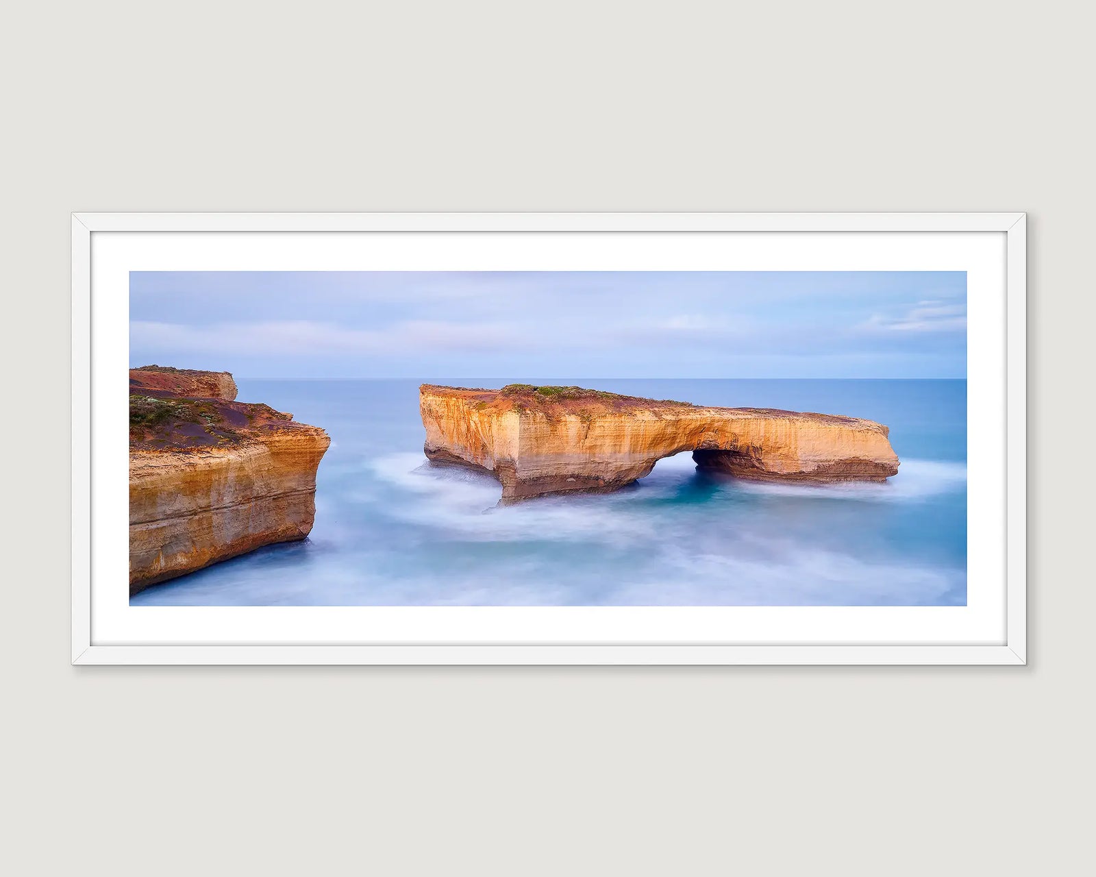 Framed wall art print of a limestone rock formation in a blue ocean, beside the Great Ocean Road in Victoria. 
