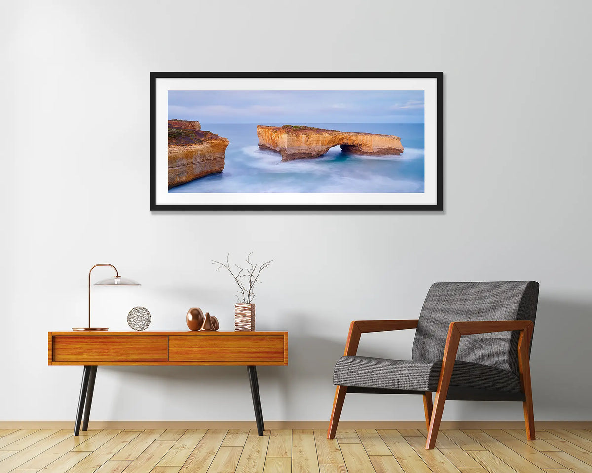 London Bridge. Great Ocean Road wall art print, framed with a black frame and hung in an entrance foyer. 