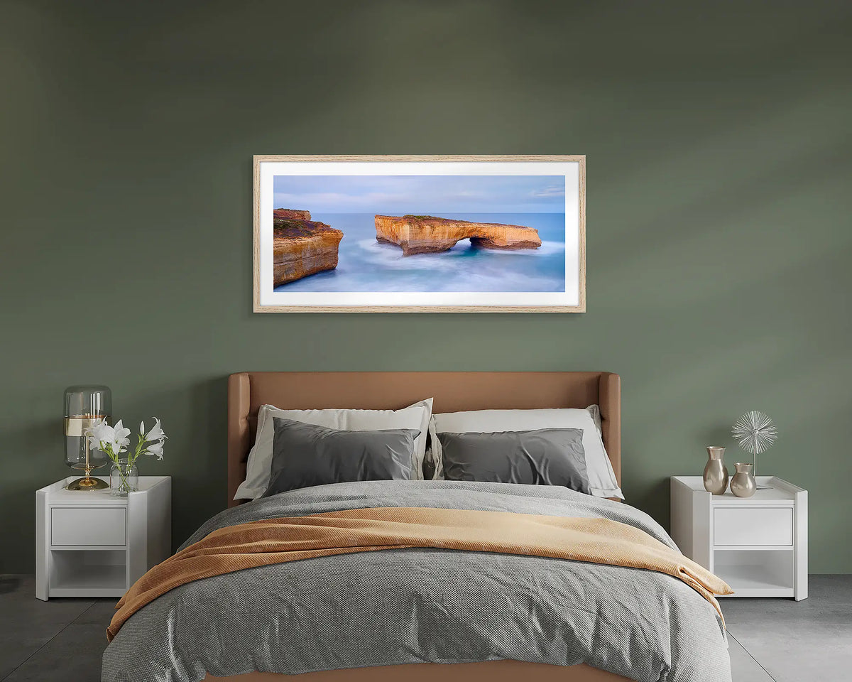 London Bridge. Great Ocean Road wall art print, framed with a Tasmanian Oak frame and hung on a bedroom wall. 