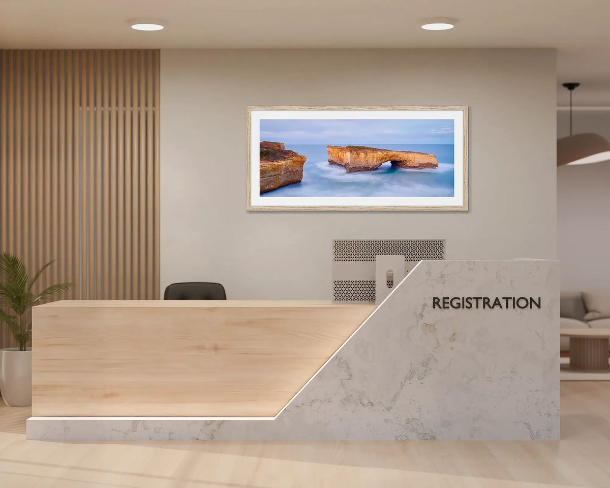 London Bridge. Great Ocean Road wall art print with a timber frame, hung behind a reception desk. 