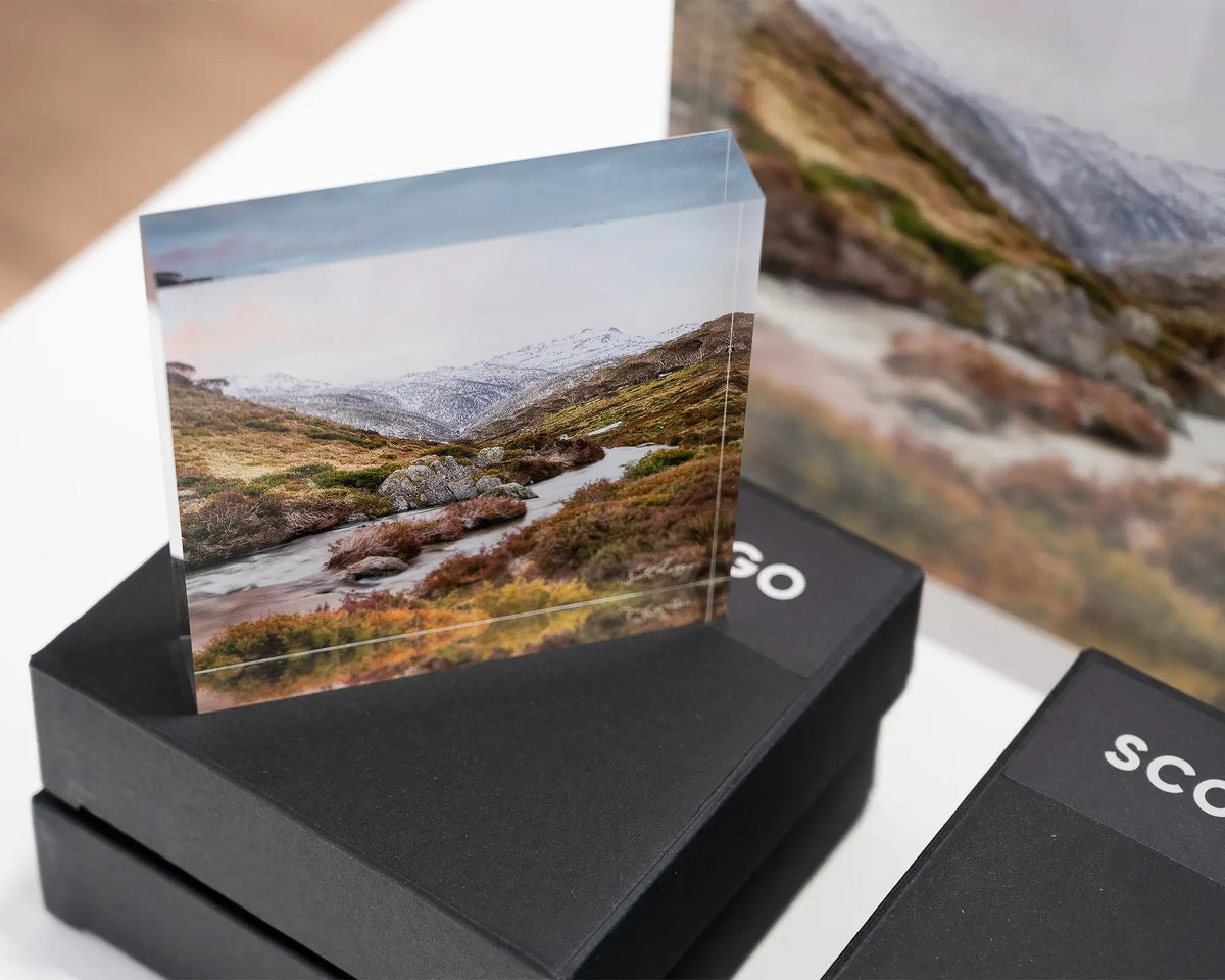 Looking Up. Acrylic block of Thredbo River, Kosciuszko National Park, on gift box with larger block behind.