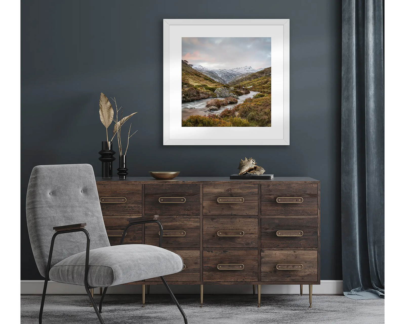 Framed wall art print of the Thredbo River flowing past heath and rocks with snow on Mount Kosciuszko in the background.