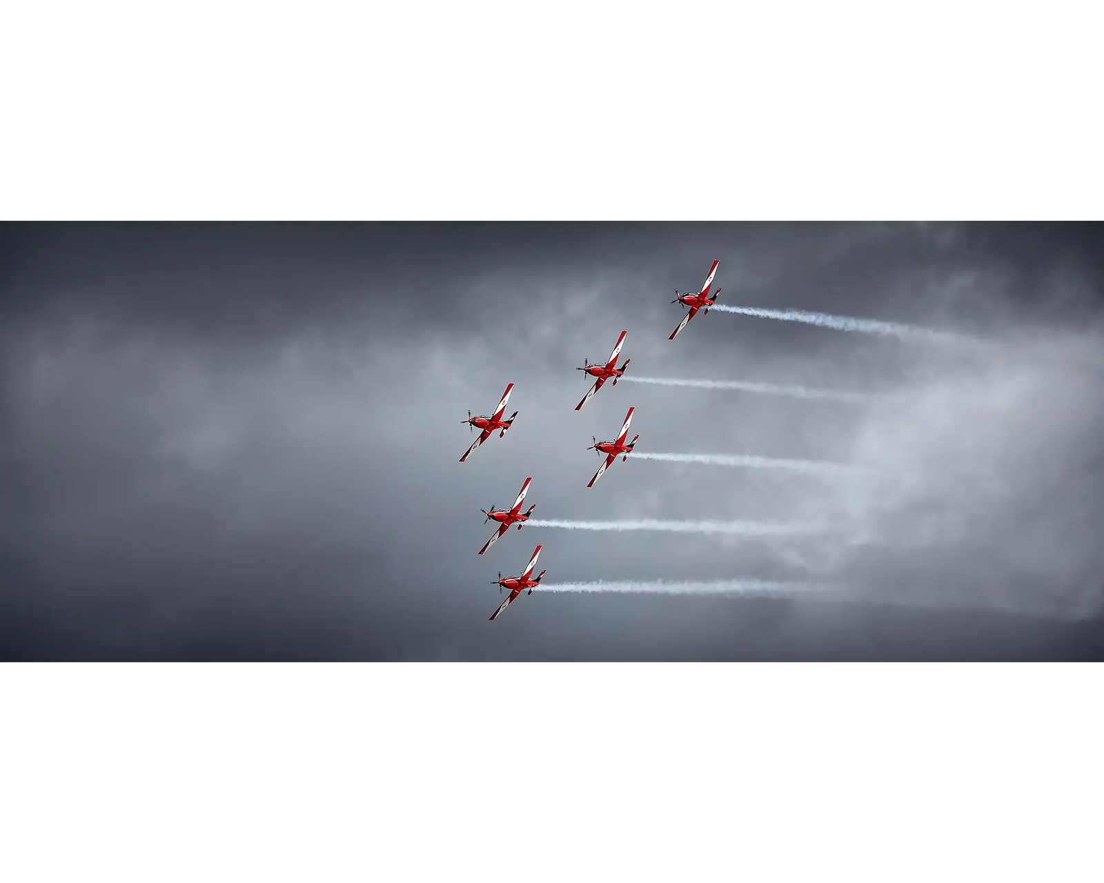 Low Show. RAAF Roulettes aerobatic team flying in formation against the backdrop of clouds.