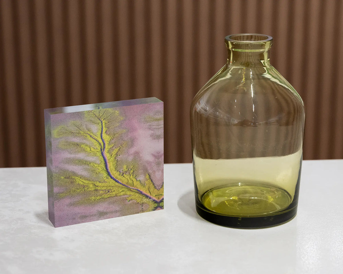 Lumination. Acrylic block aerial view of King River, The Kimberley, styled with a small vase.