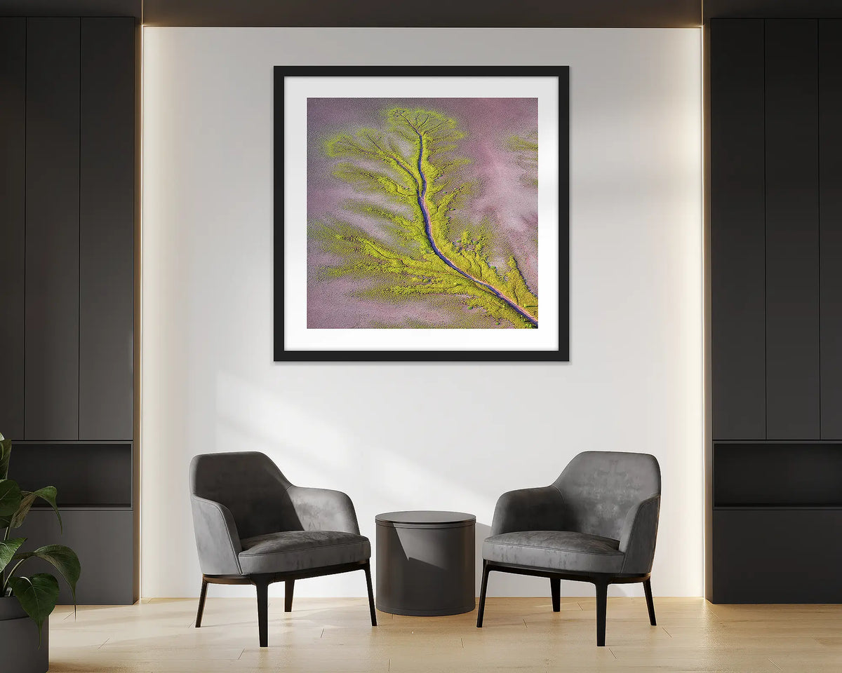 Lumination. Aerial abstract wall art print of the Kimberley, with a black frame, hung in an office reception. 