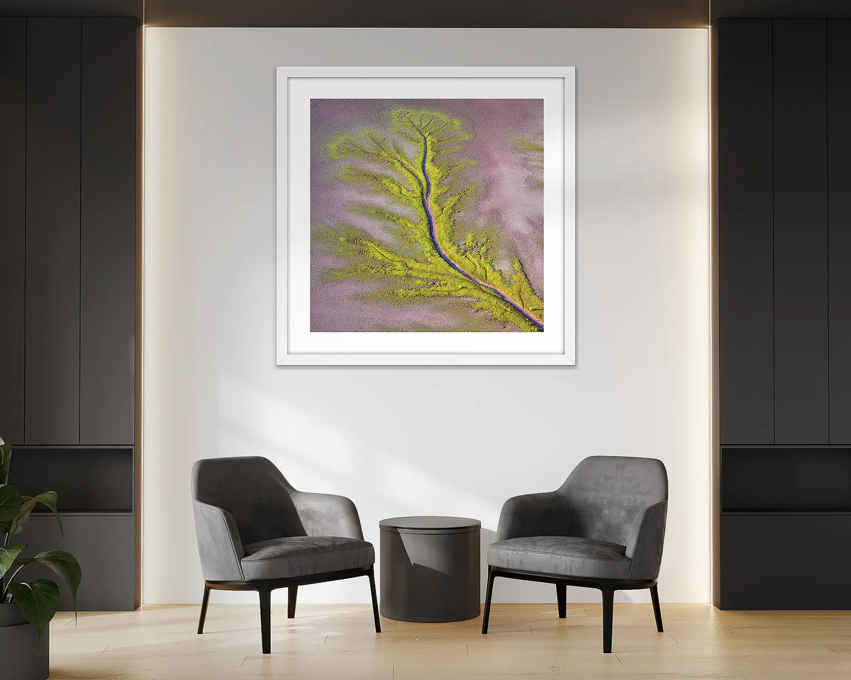 Lumination. Aerial abstract wall art print of the Kimberley, with a white frame, hung in an office reception. 