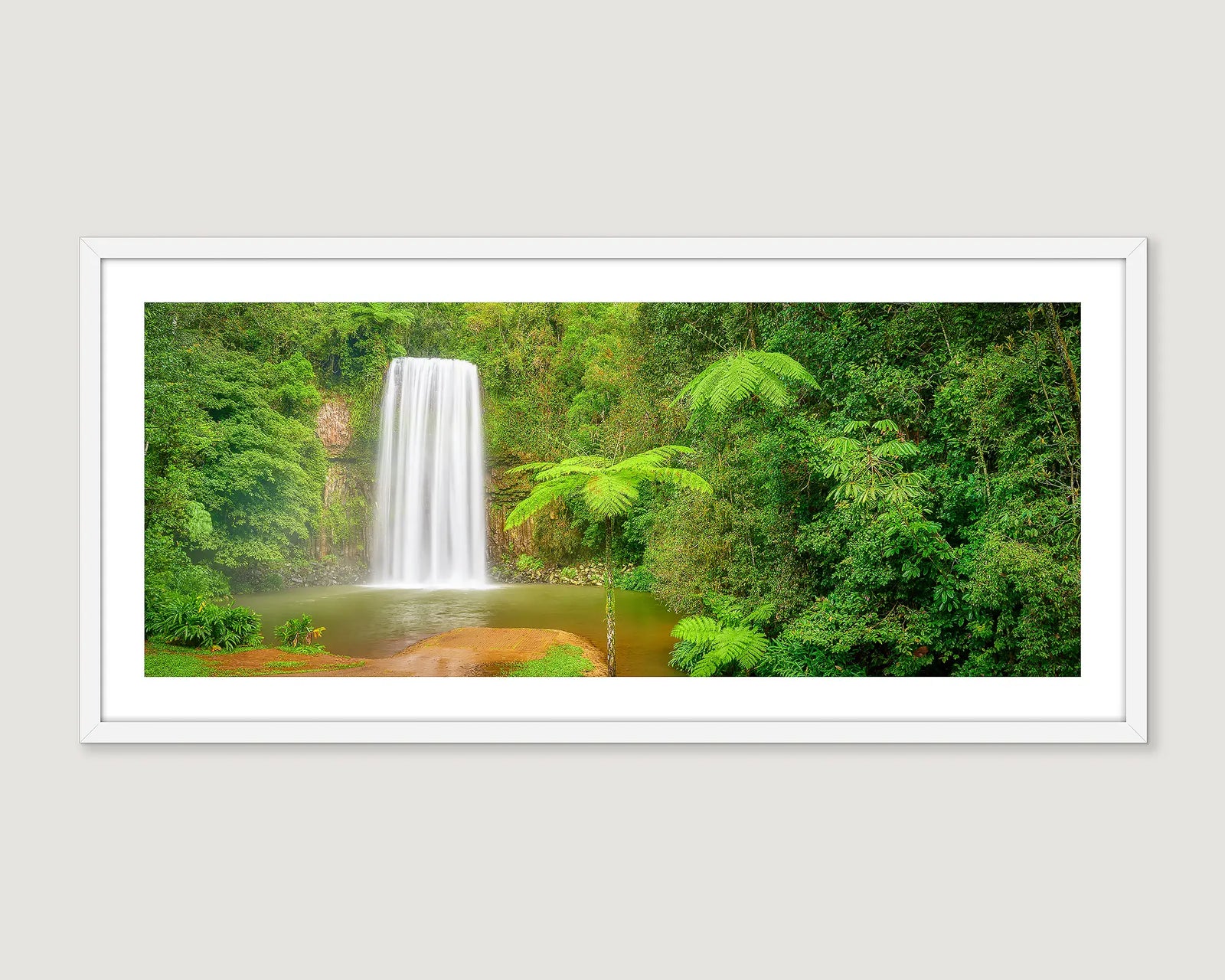 Framed wall art print of a tropical rainforest and water cascading down Milla Milla falls into a rock pool.