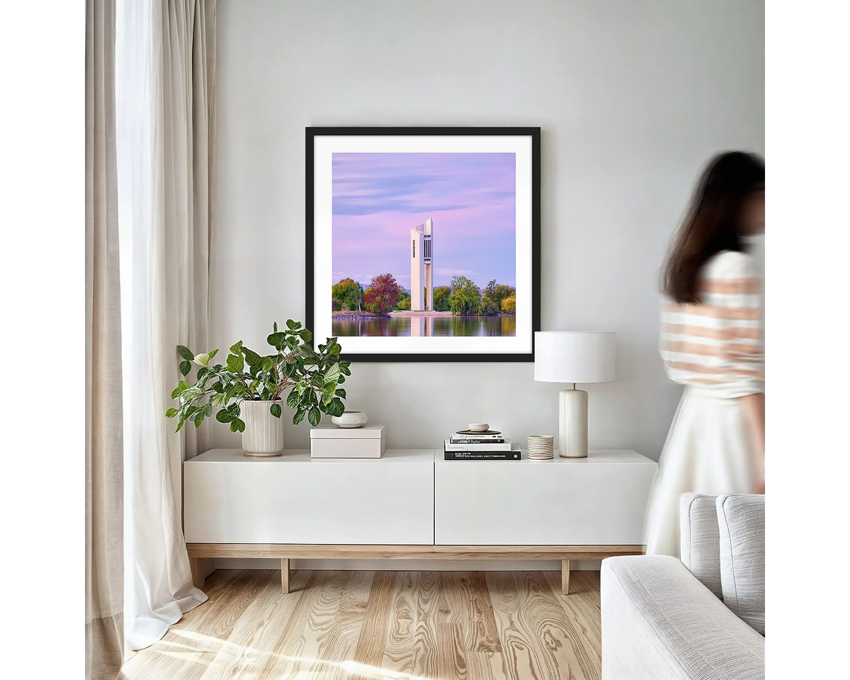 Magenta Dawn. Canberra wall art print with black frame hung in a small lounge room.