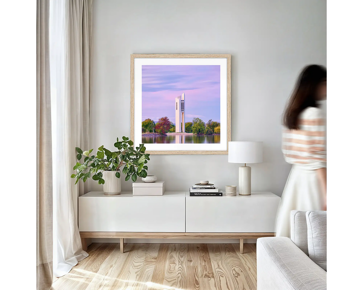 Magenta Dawn. Canberra wall art print with timber frame hung in a small lounge room.