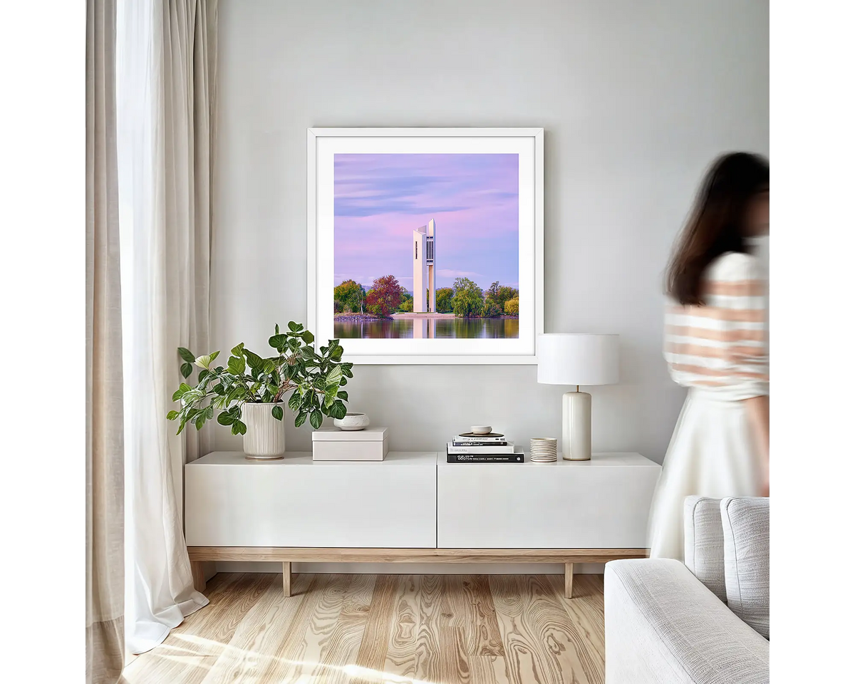 Magenta Dawn. Canberra wall art print with white frame hung in a small lounge room.