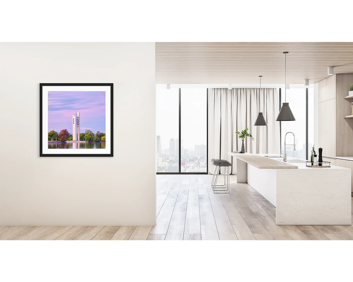 Magenta Dawn. Framed wall art print of the National Carillon, Canberra, with a black frame hung on a hallway wall. 