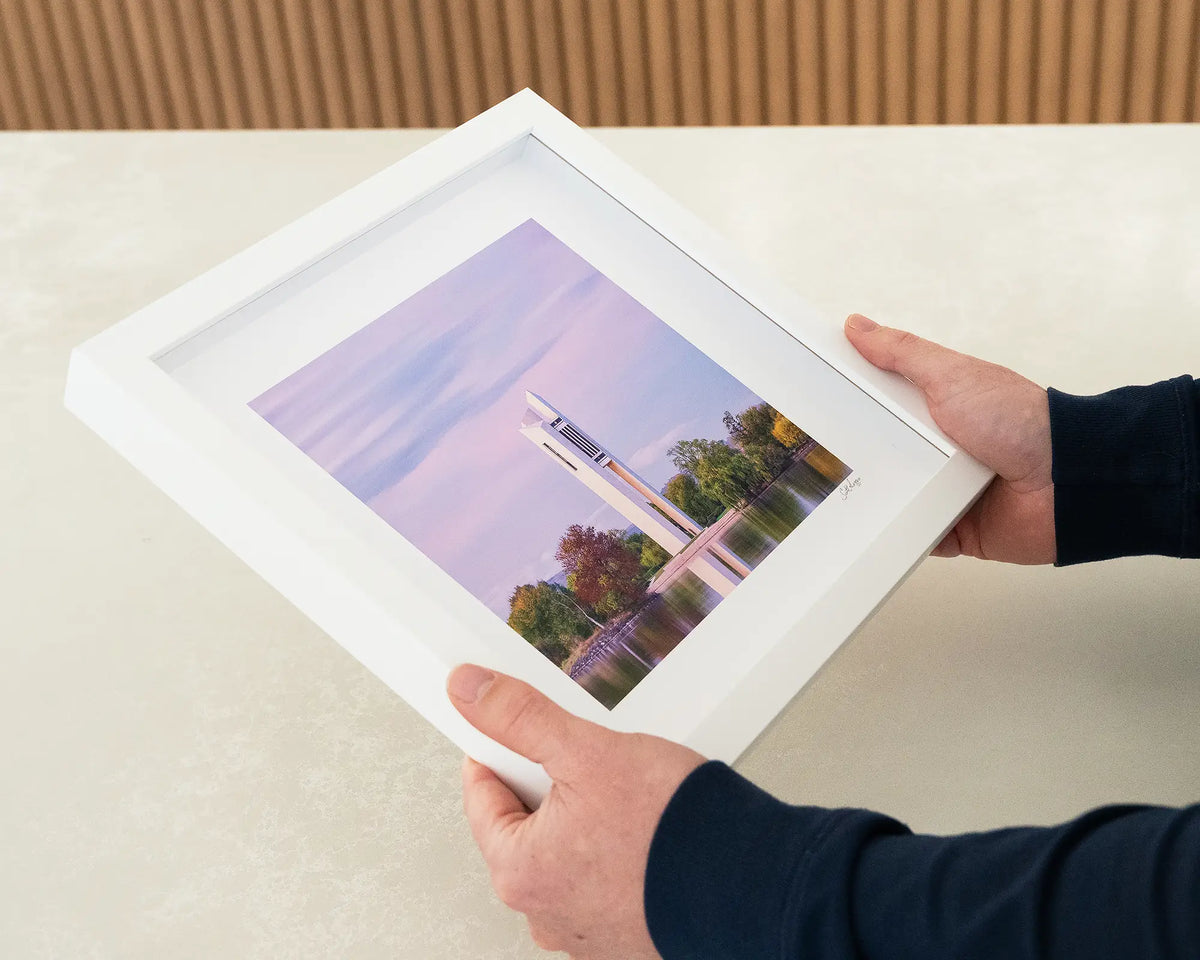 Magenta Dawn. Small framed print with white frame, National Carillon Canberra, being hand held.