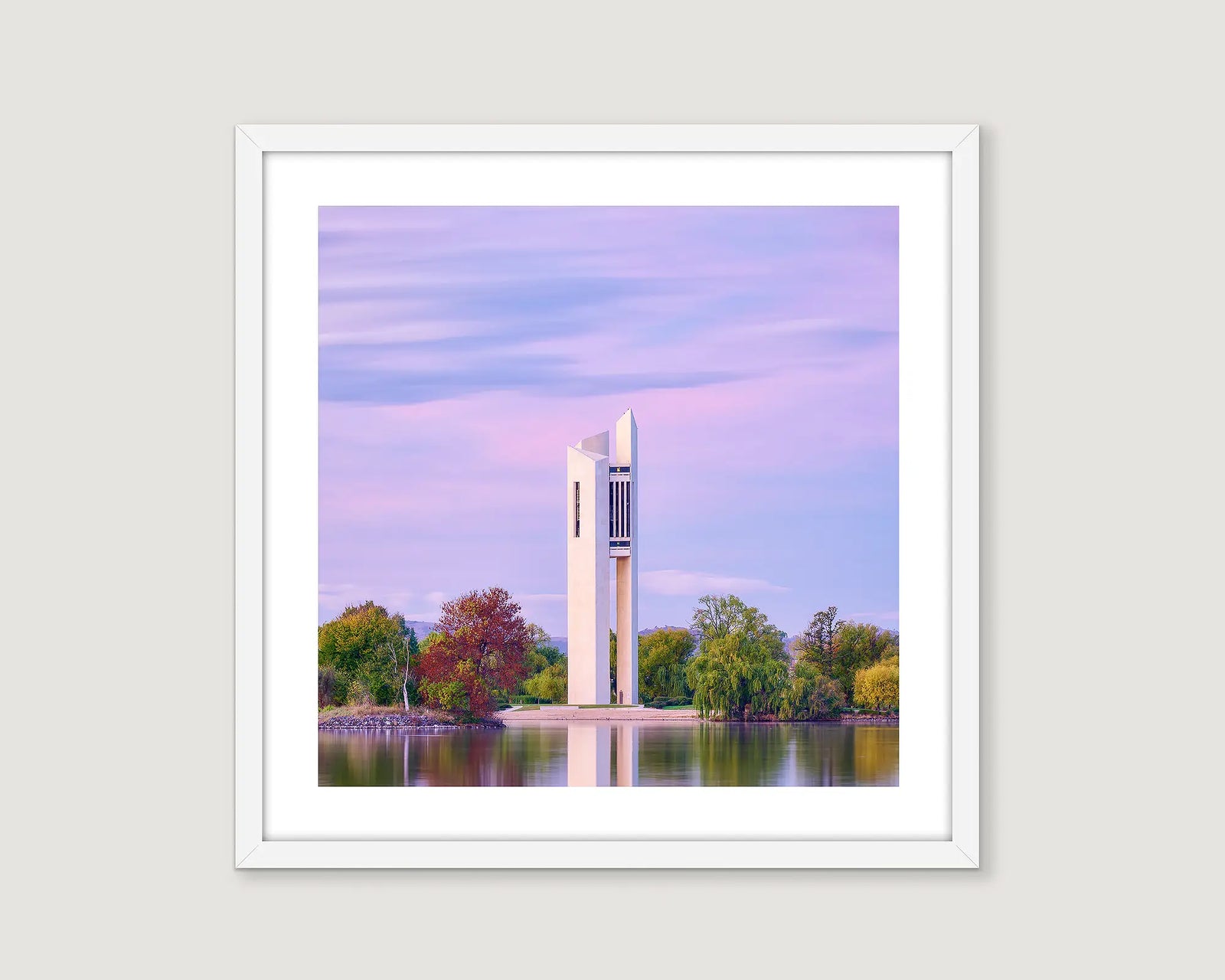 Framed photograph of the Carillon on the lake with a purple sunrise.