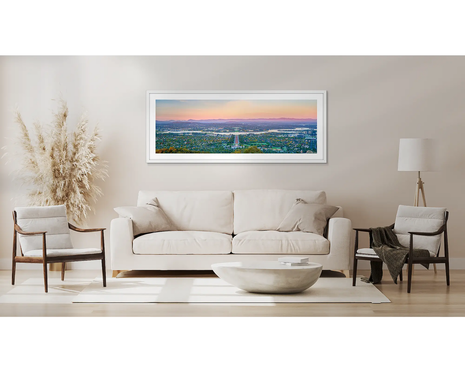 Framed photograph of a view of Canberra and the Brindabella Ranges at sunrise.