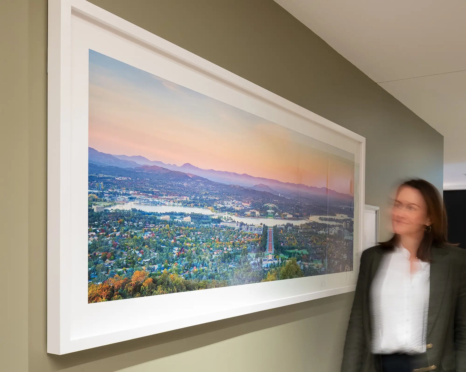 Framed photograph of a view of Canberra and the Brindabella Ranges at sunrise.