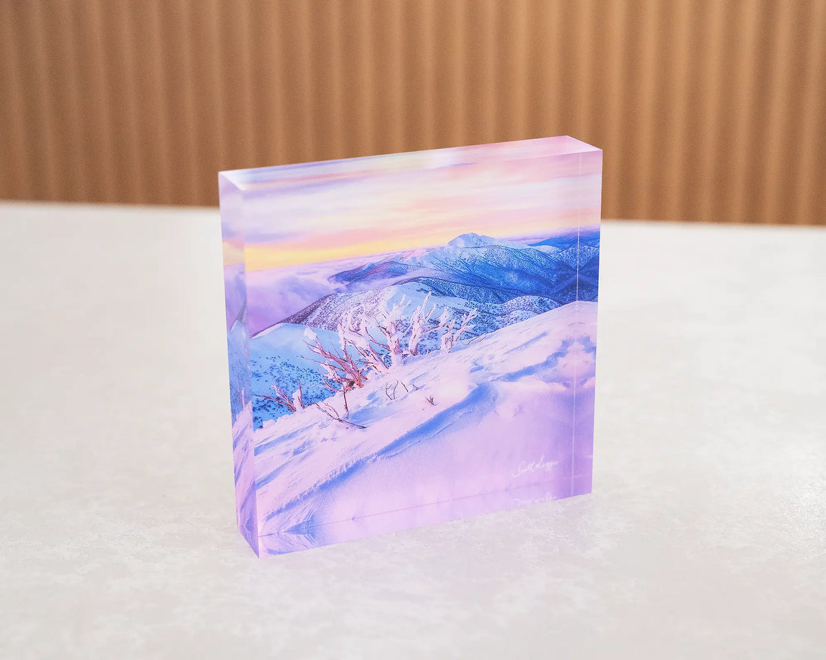 Memories of Winter. Acrylic block of sunset light over Mount Feathertop, sitting on a desk.